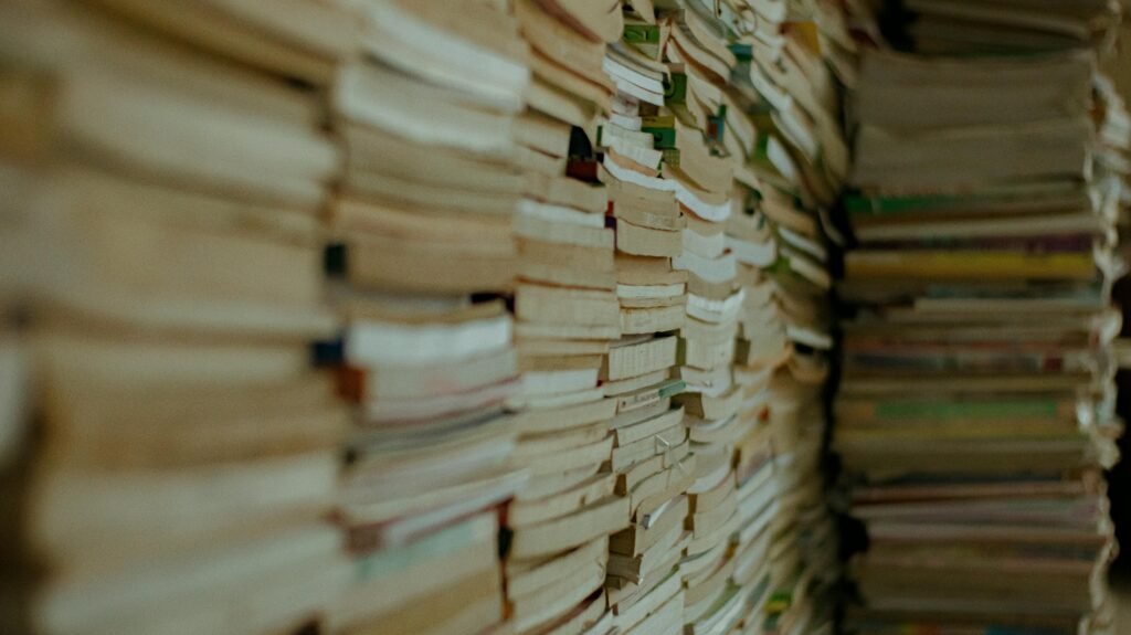 Close-up of stacked vintage paperbacks creating a textured, historical ambiance.