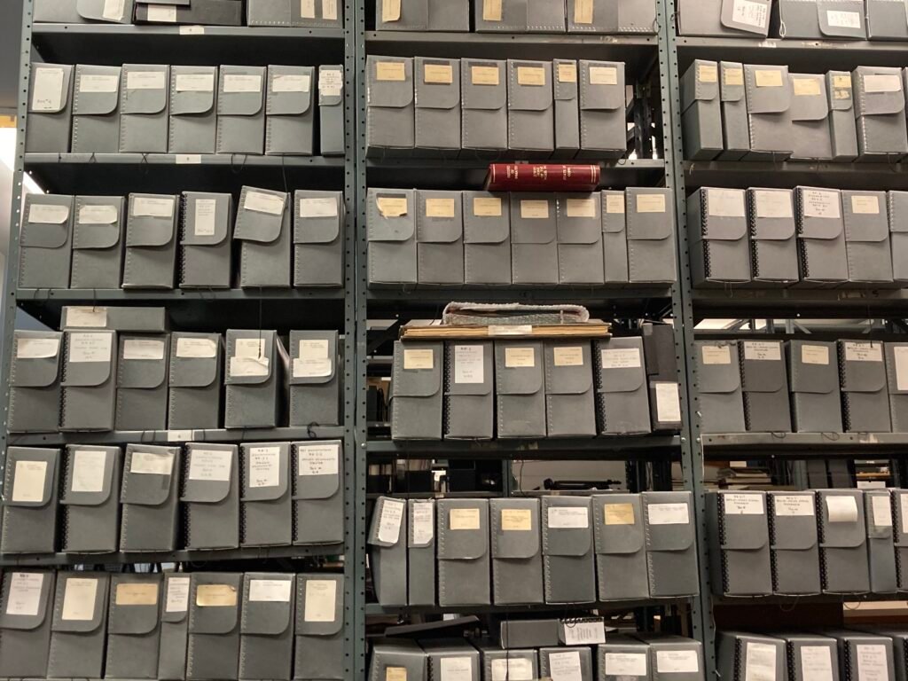 Image shows five rows of archival shelving filled with document boxes