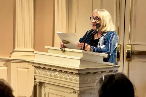 Rhoda Samuel speaking at the podium